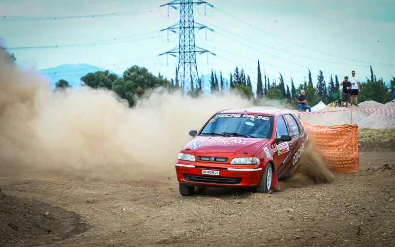the car is racing while blowing the dust up