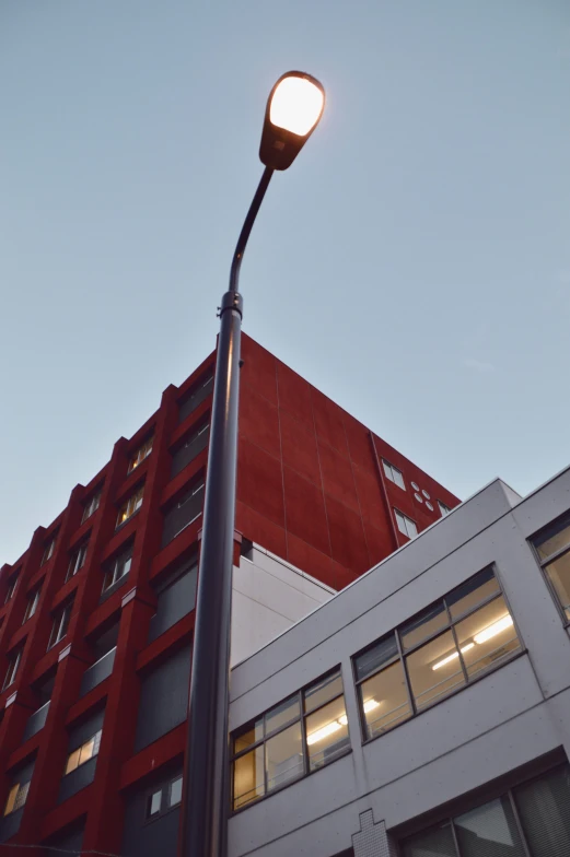 a street light attached to a pole on top of a building