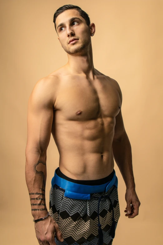 a male model with  wearing a patterned trunks