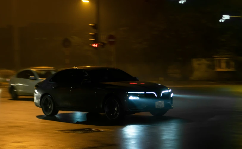 a car moving fast on the road at night