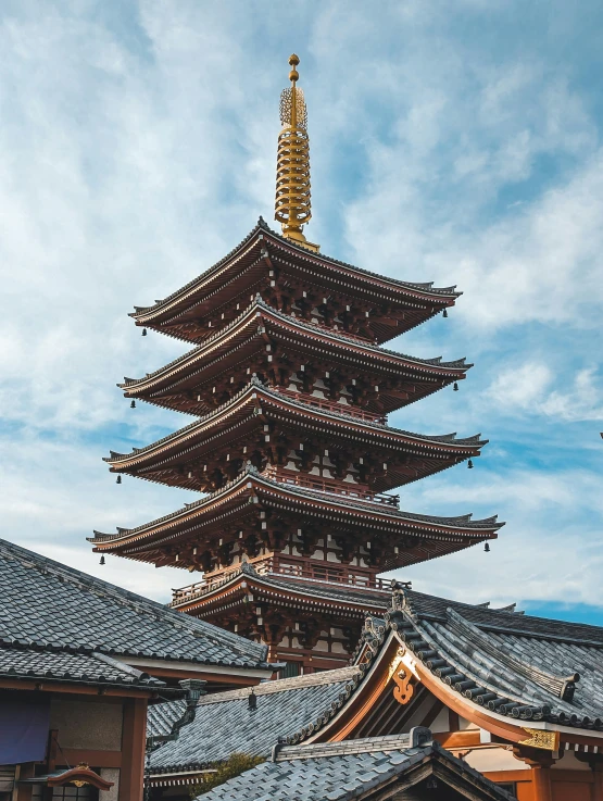 the tall asian pagoda towering over many roofs