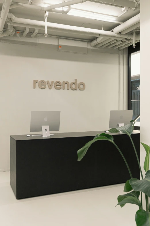 a black and white office with the name revendo on the wall