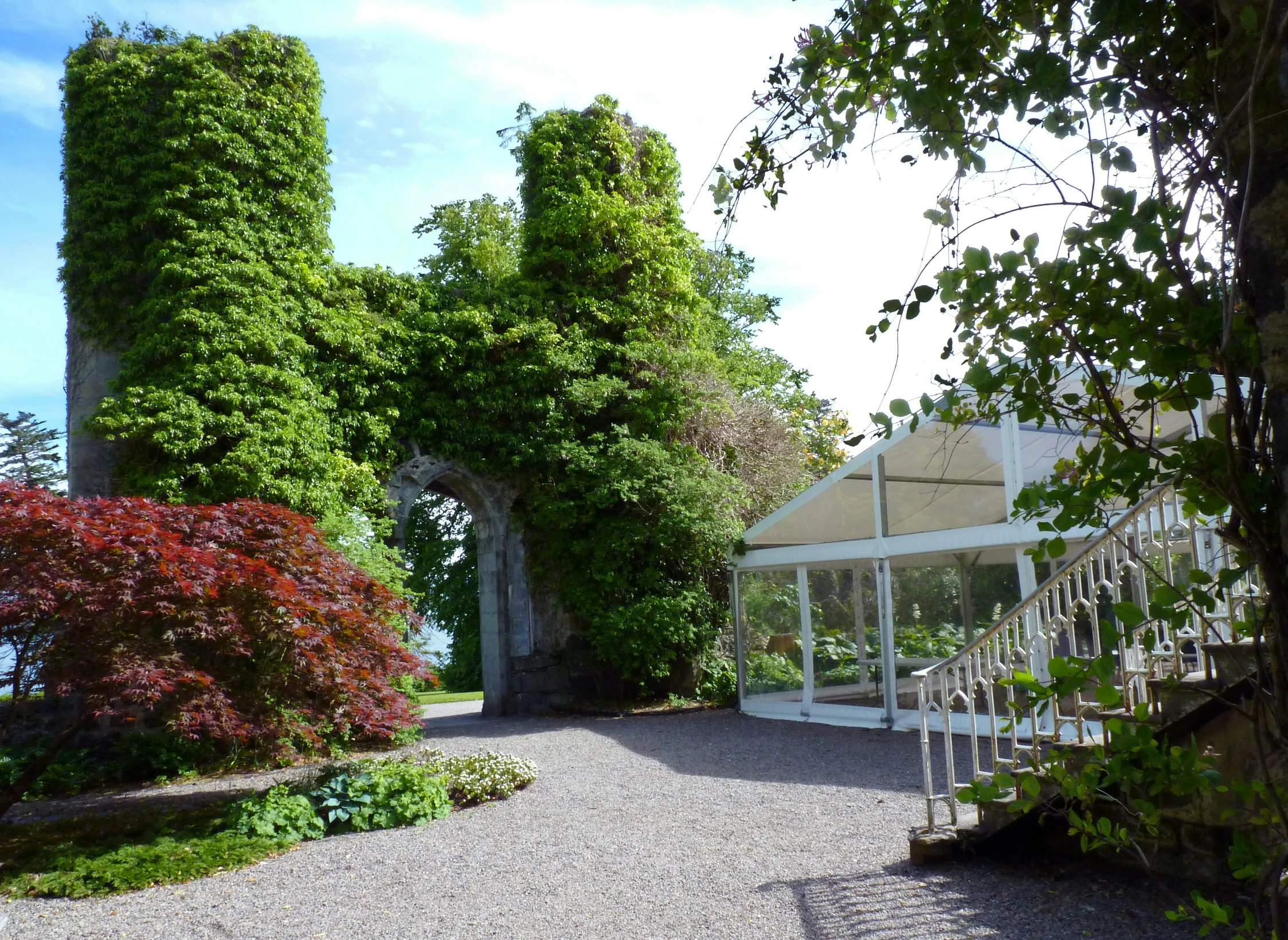 a walkway leading through to a green garden