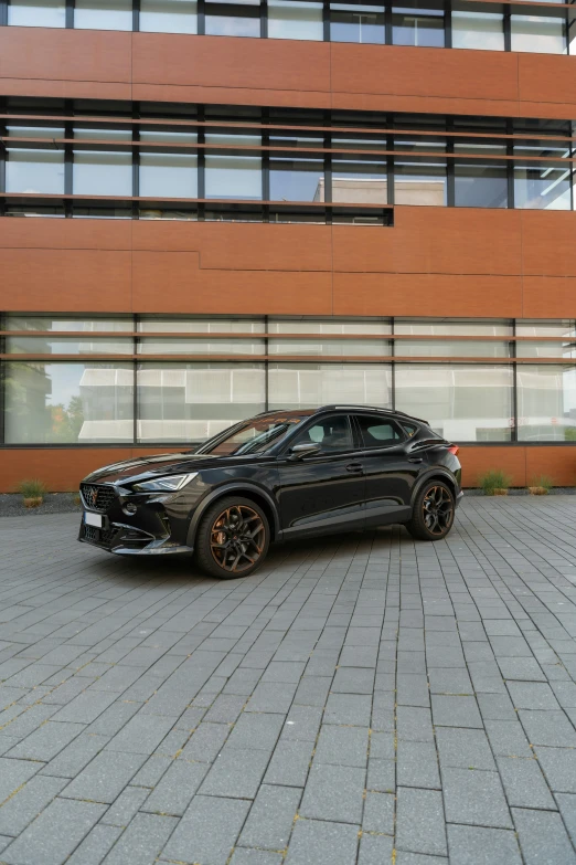 two cars parked side by side in front of an orange building