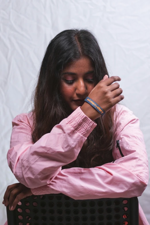 woman dressed in pink praying and looking down