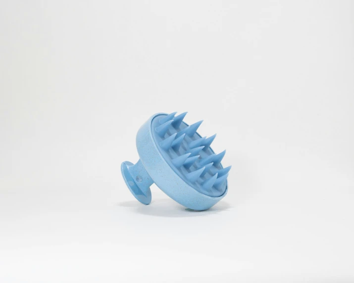 a blue plastic animal shaped object against a white background