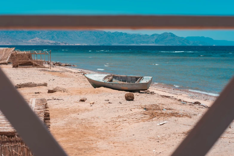 a view of the ocean from behind some bars