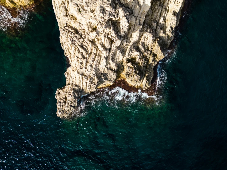 an aerial view of some cliffs and the water