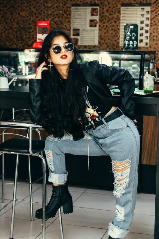 woman wearing black sunglasses posing at the counter