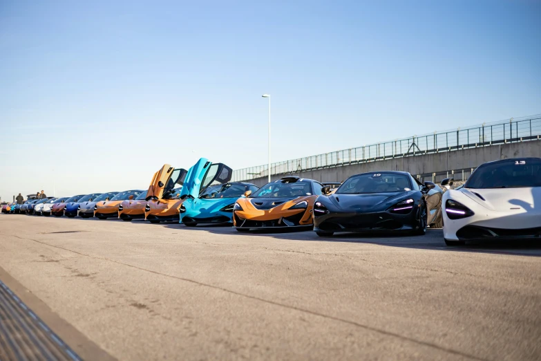 a line up of sports cars parked next to each other