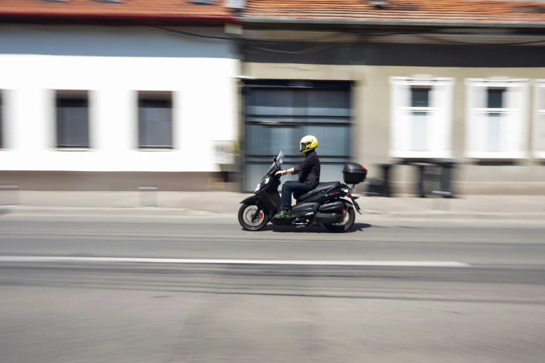 a man riding a motorcycle on a city street