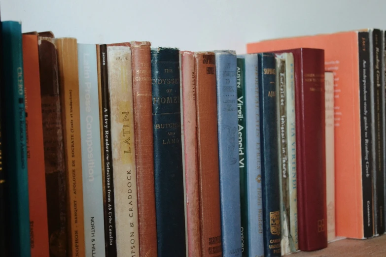 an old set of books on top of the shelf