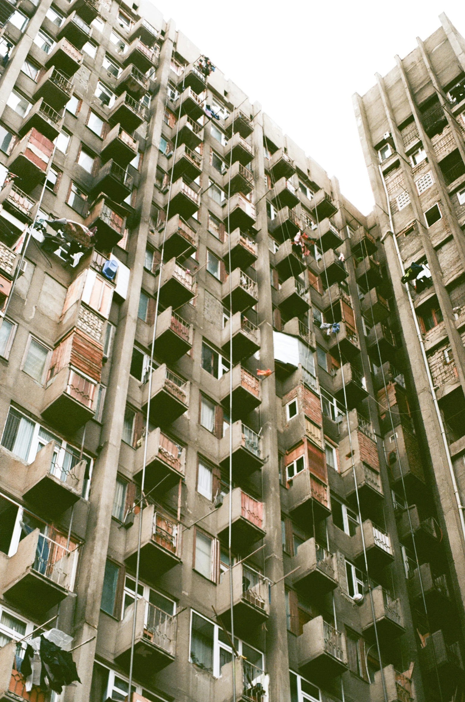 multiple windows and balconies on large apartment building