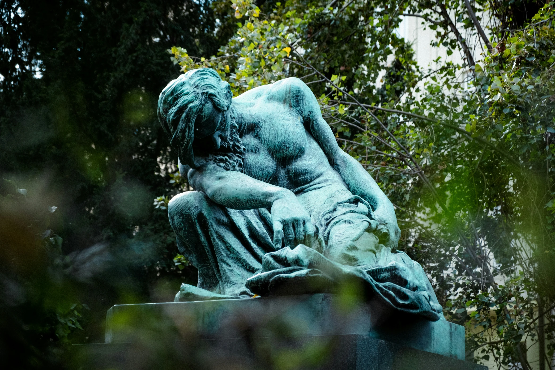 the statue sits in a clearing among the trees