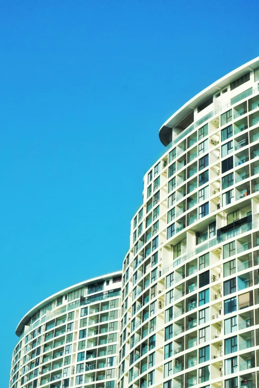 the bottom part of a building with lots of balconies