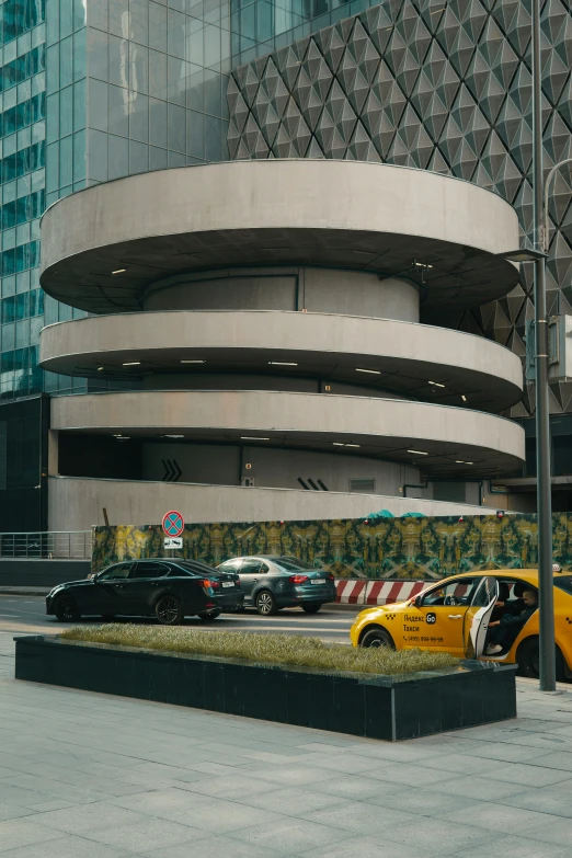 an elegant building with several cars parked outside