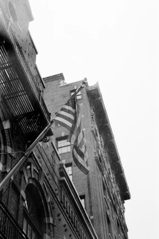 an old building with flags hanging off it