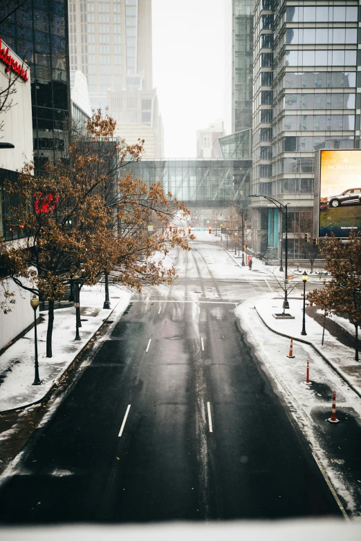 a city street on a snowy day with skyscrs