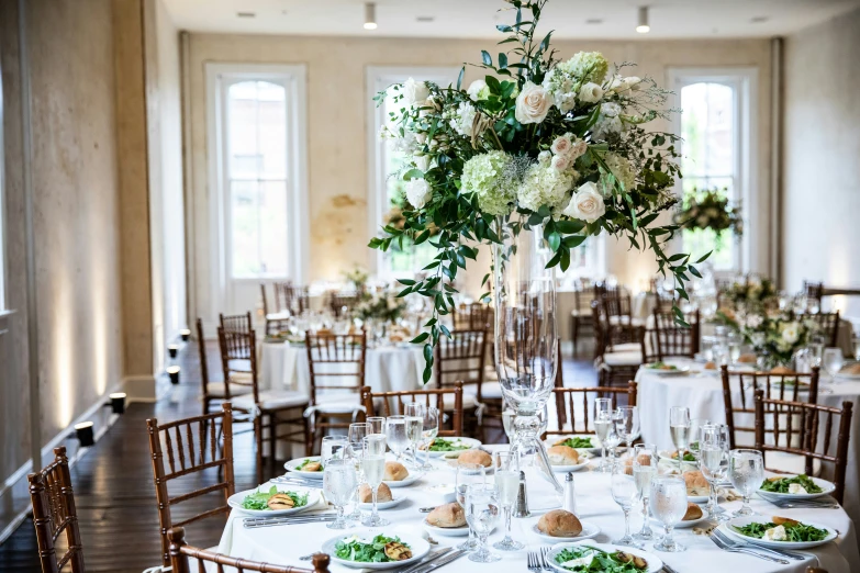 a wedding reception setup with greenery and candles