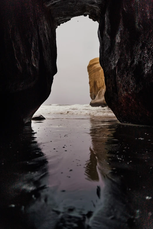 an ocean cave that looks like a huge waterfall