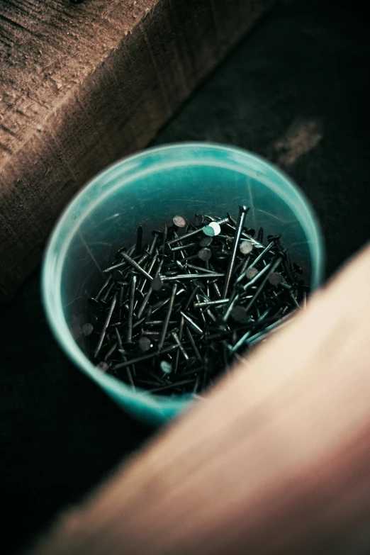 close up view of several nail nails in a bowl