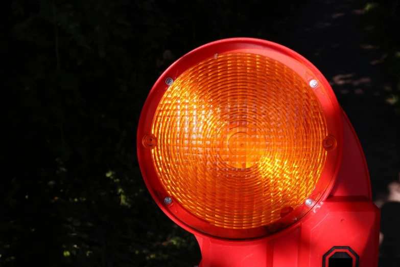 the back side of a traffic light with trees in the background