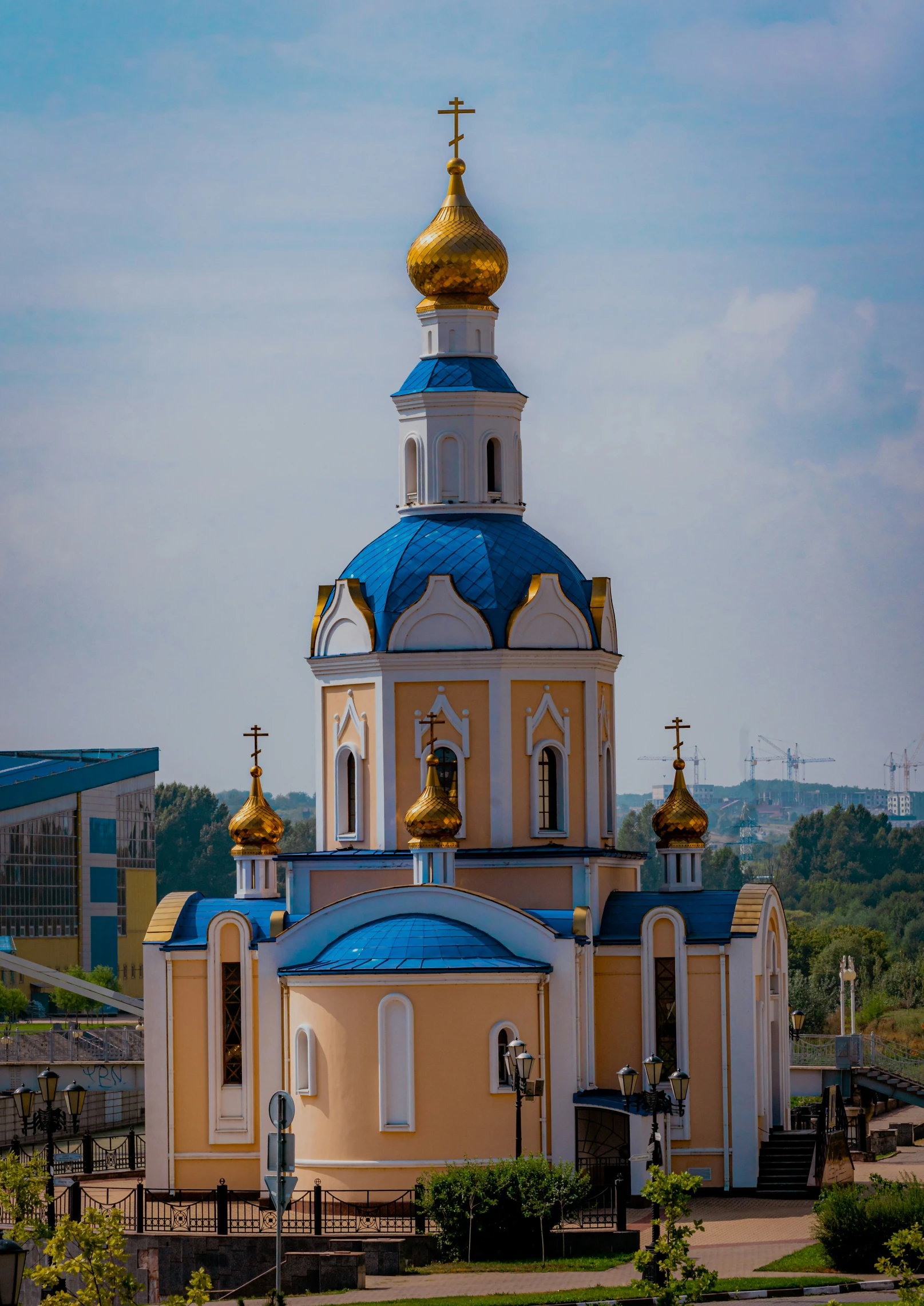 the front of a church with blue and gold steeples