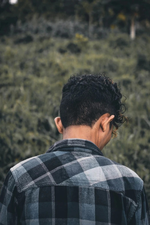 a man is standing in the field with an intense look on his face