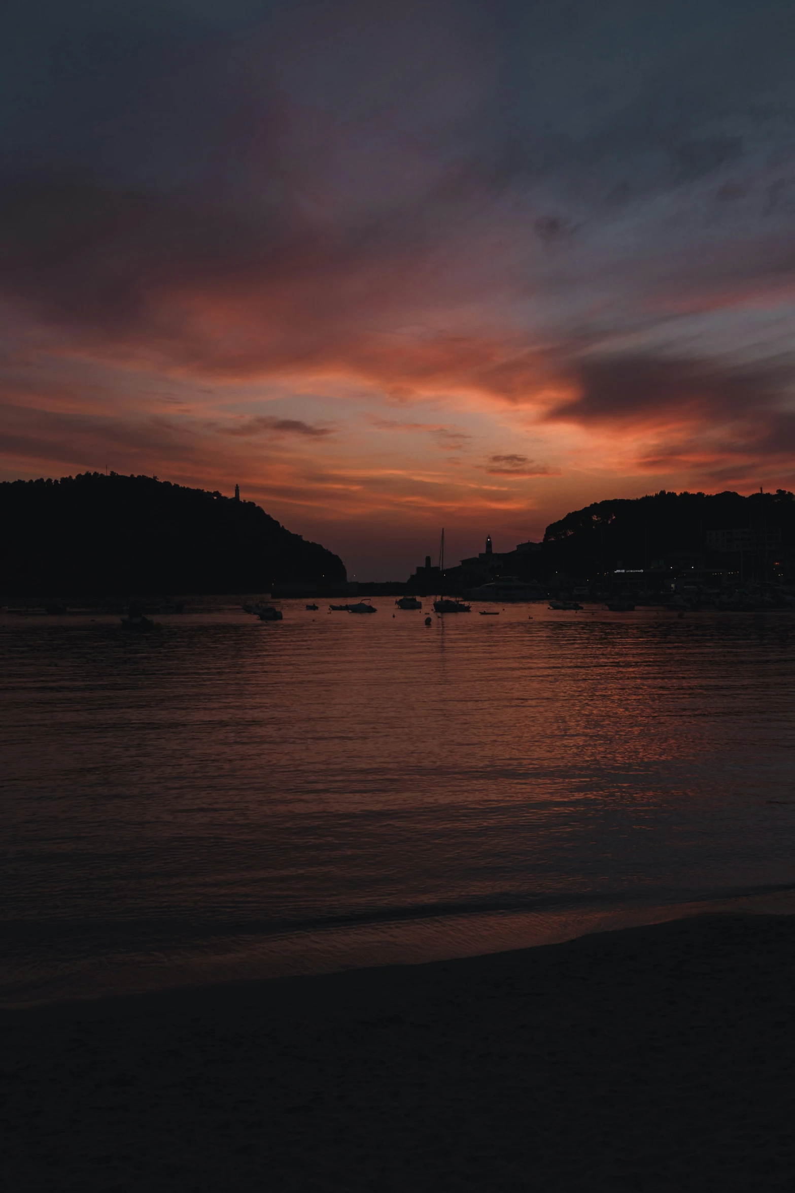 a boat in a body of water next to a hill