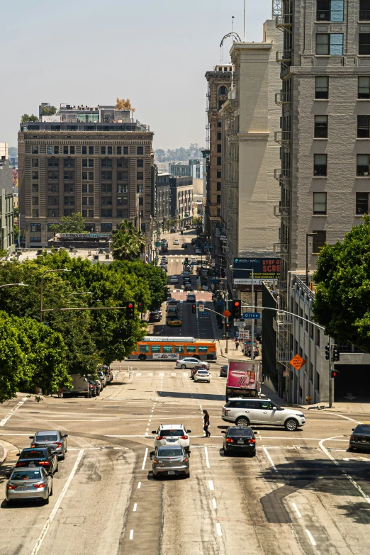 an aerial view of an urban city with cars on the road