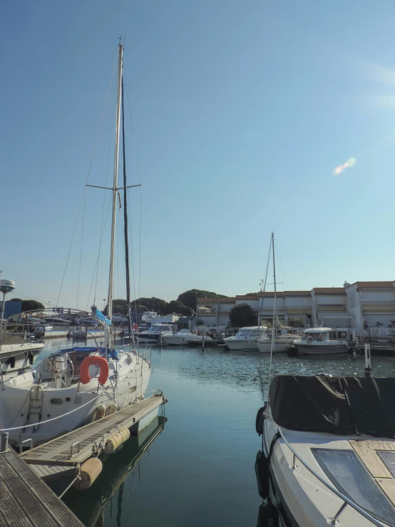 several boats docked in a harbor on a sunny day