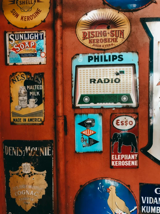 an orange metal door with signs and signs on it