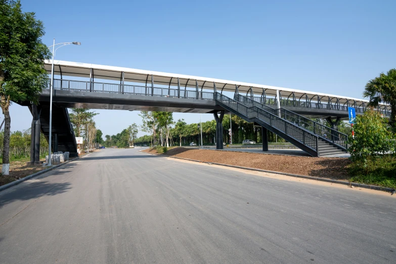 a black and white staircase bridge over an open road