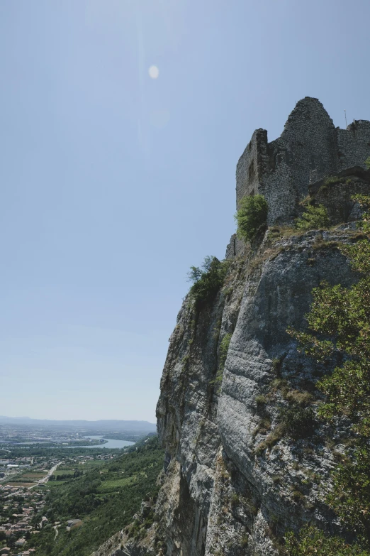 there is a rocky cliff with a tower on top