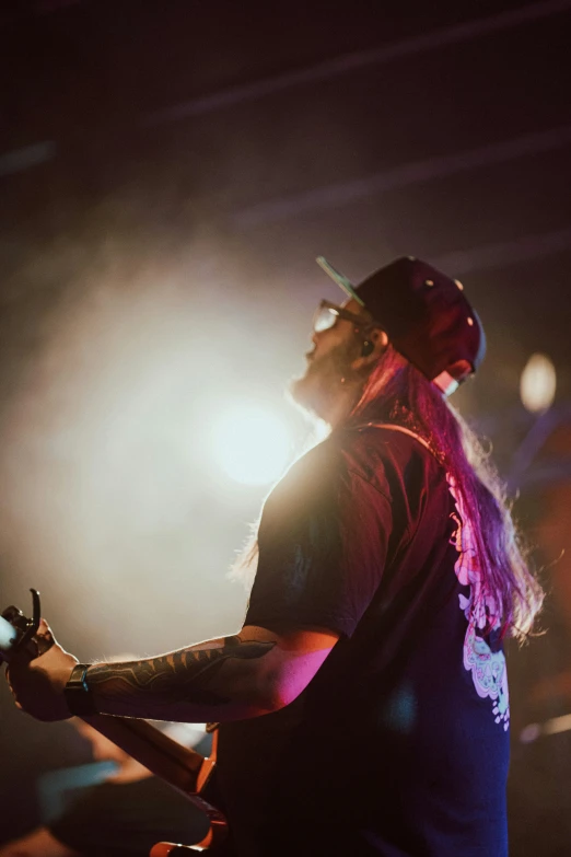 a man holding a guitar in front of people