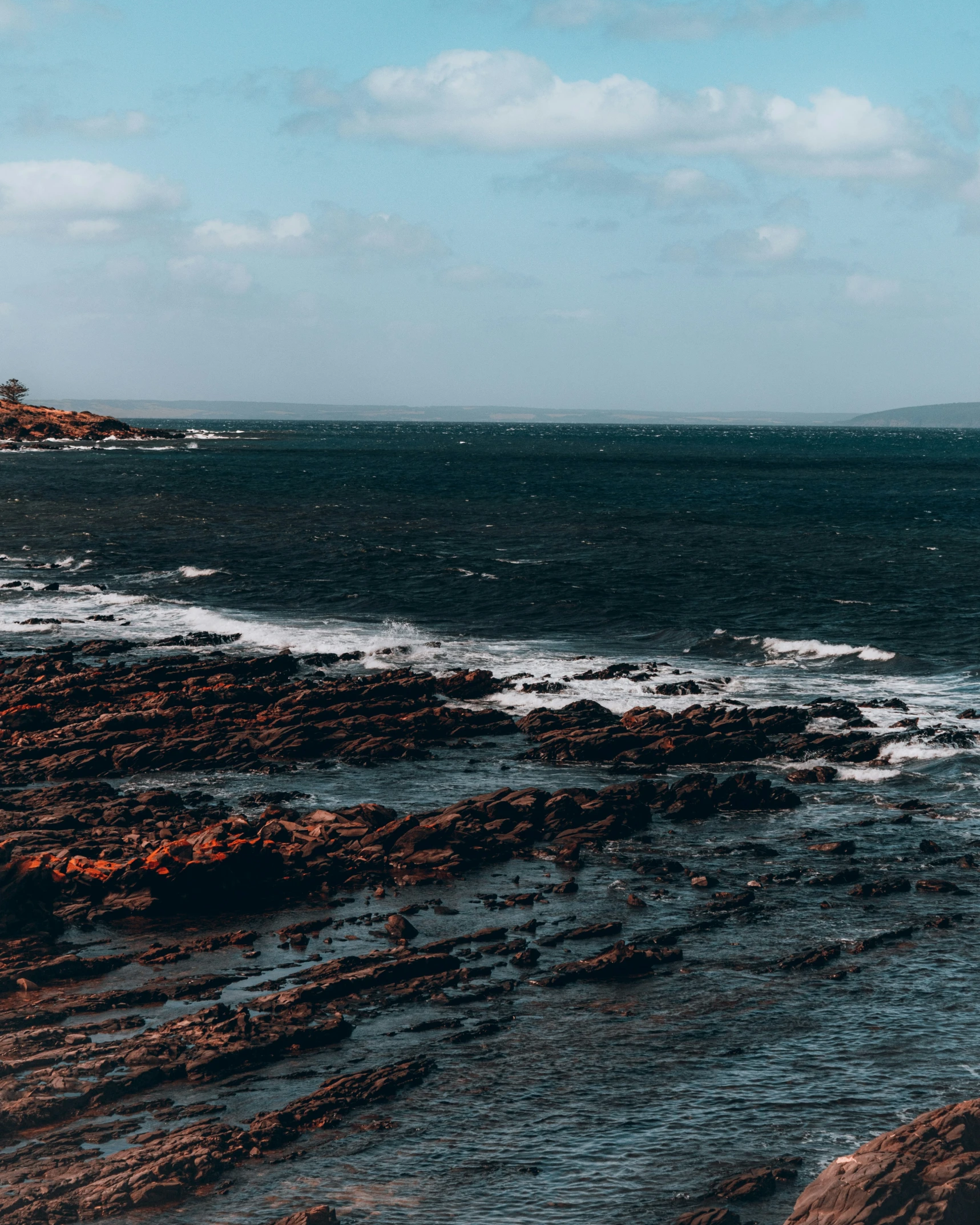 a beach scene with the shore looking towards the ocean