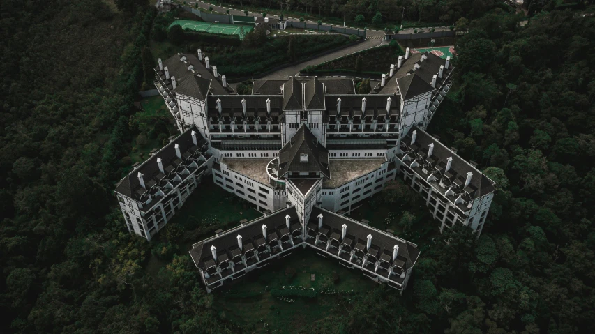 a building in a lot surrounded by trees