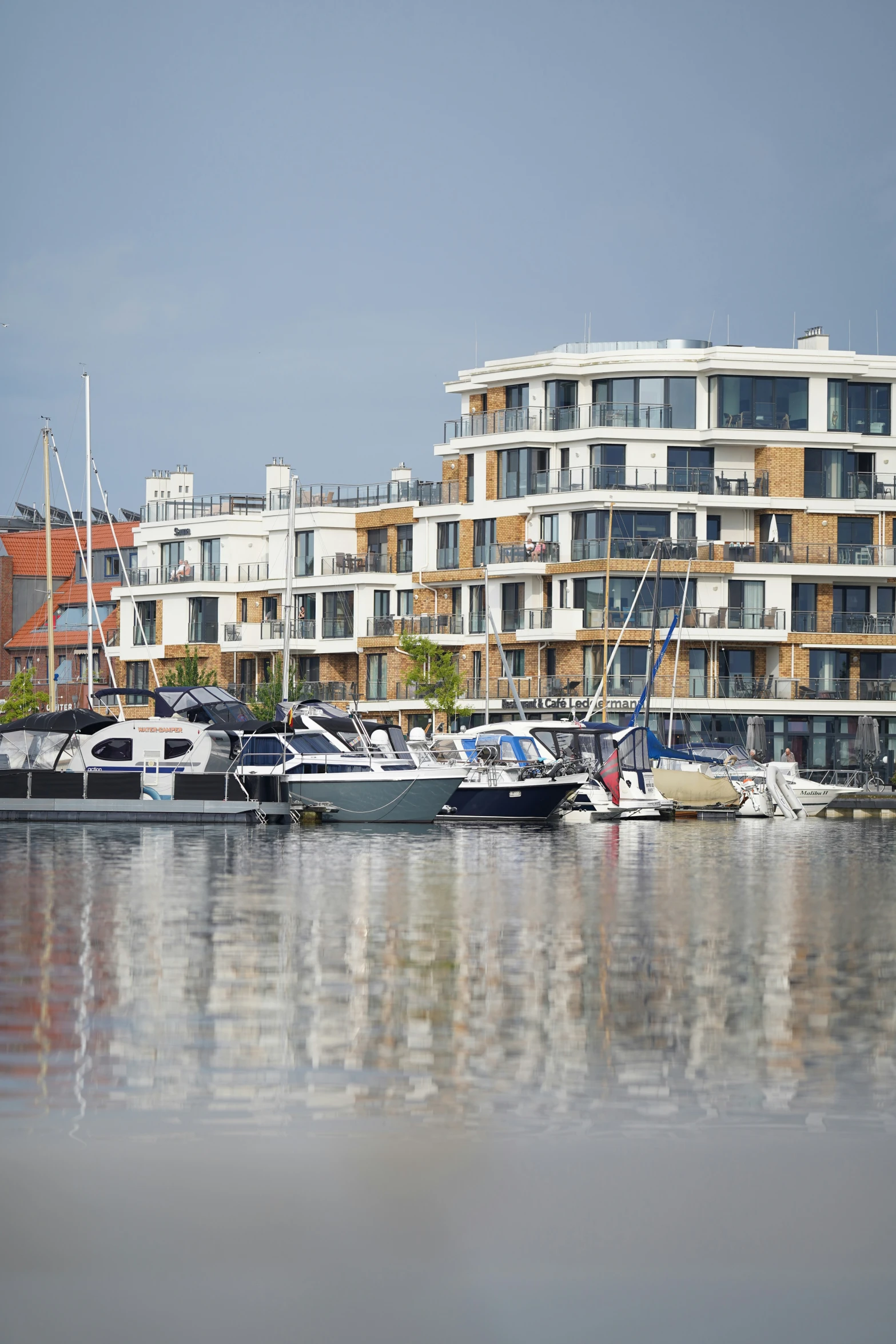 a large building next to boats in a body of water