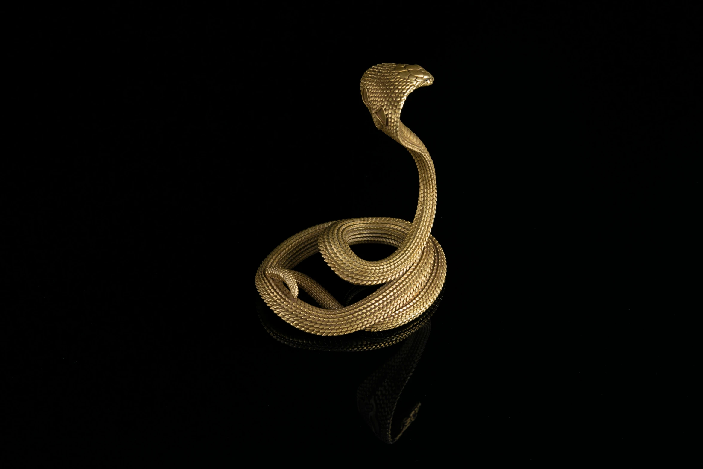 a snake statue made from gold chains