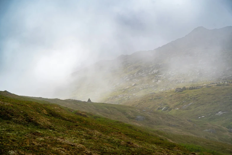 a group of people on top of a hill in the mountains