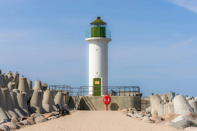 the lighthouse on top of a mountain is surrounded by many large rocks