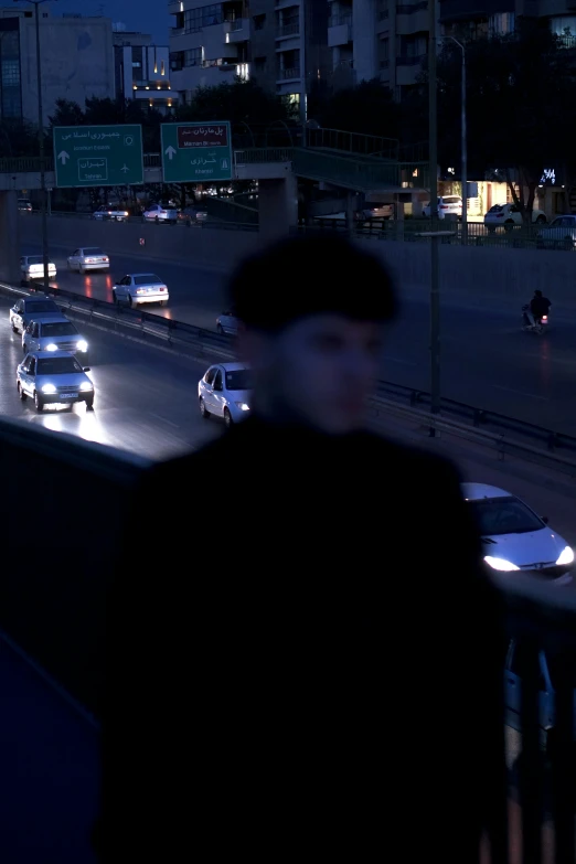 man in black jacket and hat walking on city street