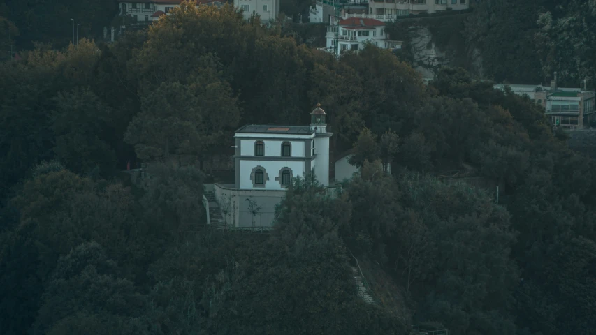 a white building nestled in the trees