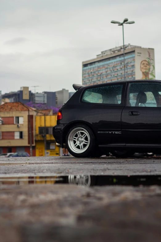 black car in front of an overcast city street