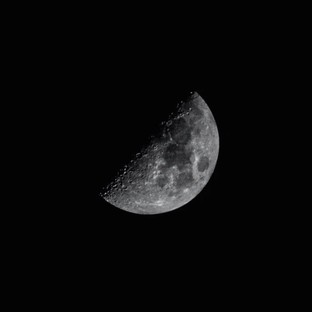 the moon in the night sky is almost black