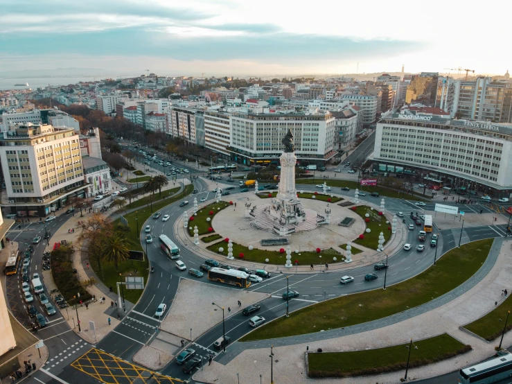 an aerial view of the city center with a circular park, street light and large buildings