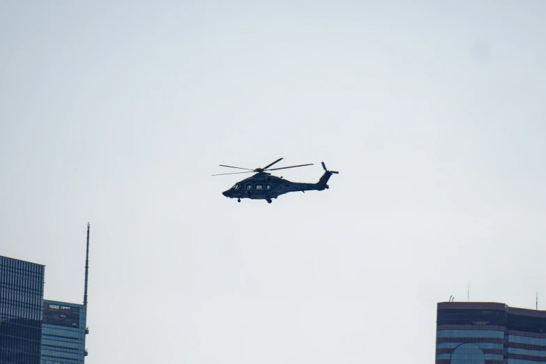 a large helicopter flying over a large city