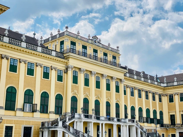 the courtyards and stairs in front of a big yellow building