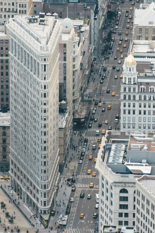 a city skyline shows the top floors and traffic in two streets