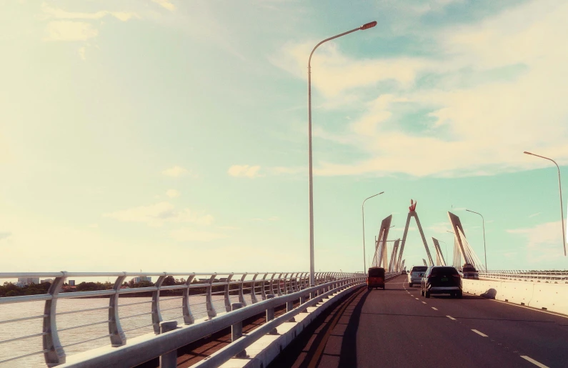 a car driving across a bridge on a sunny day